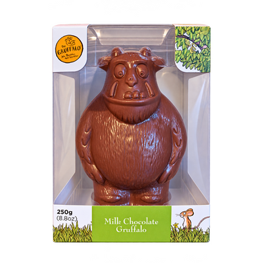 A milk chocolate Gruffalo figure in its original retail packaging, featuring a clear plastic window, a white and green base, and the Gruffalo logo.